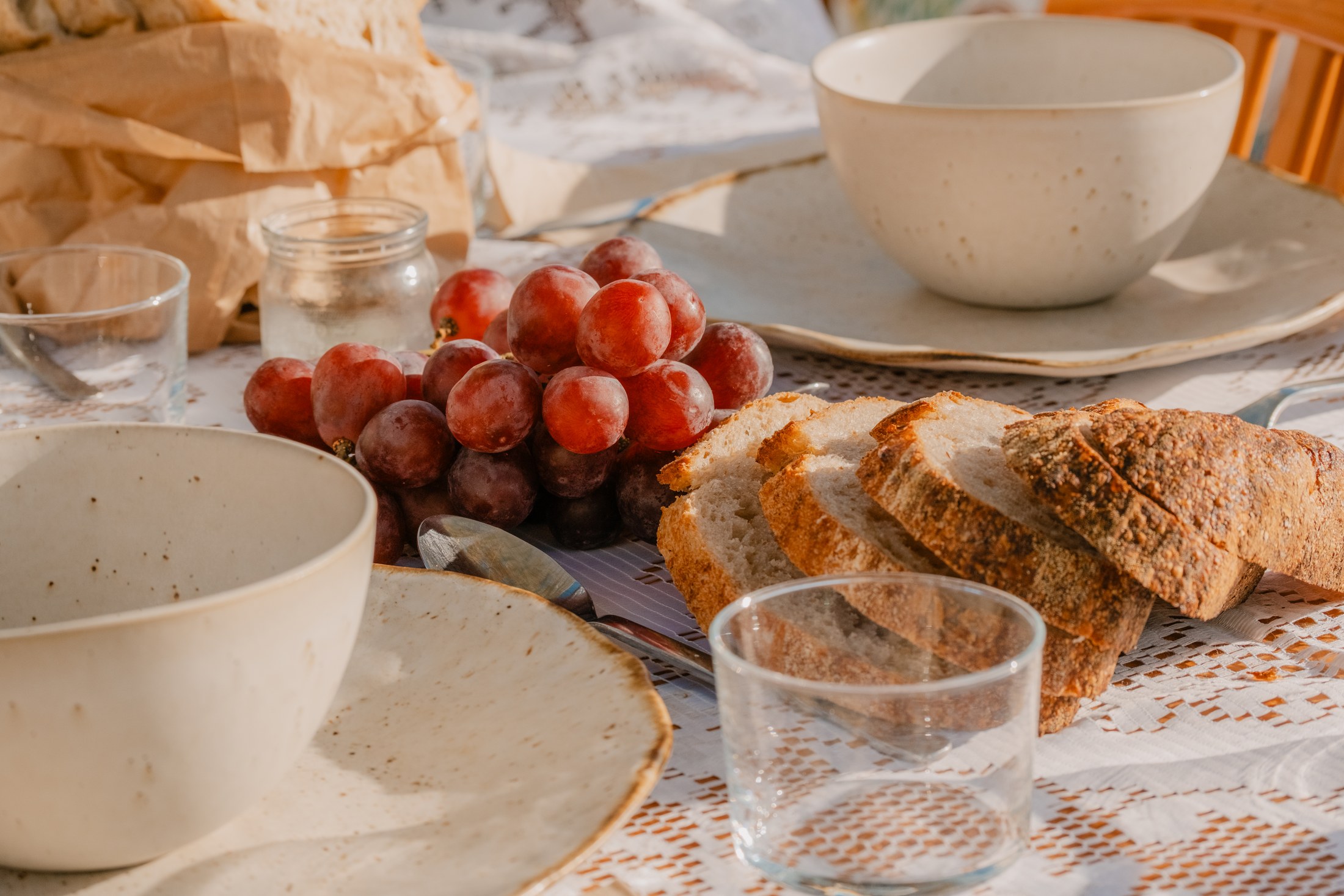 Bread, grapes and ceramic tableware