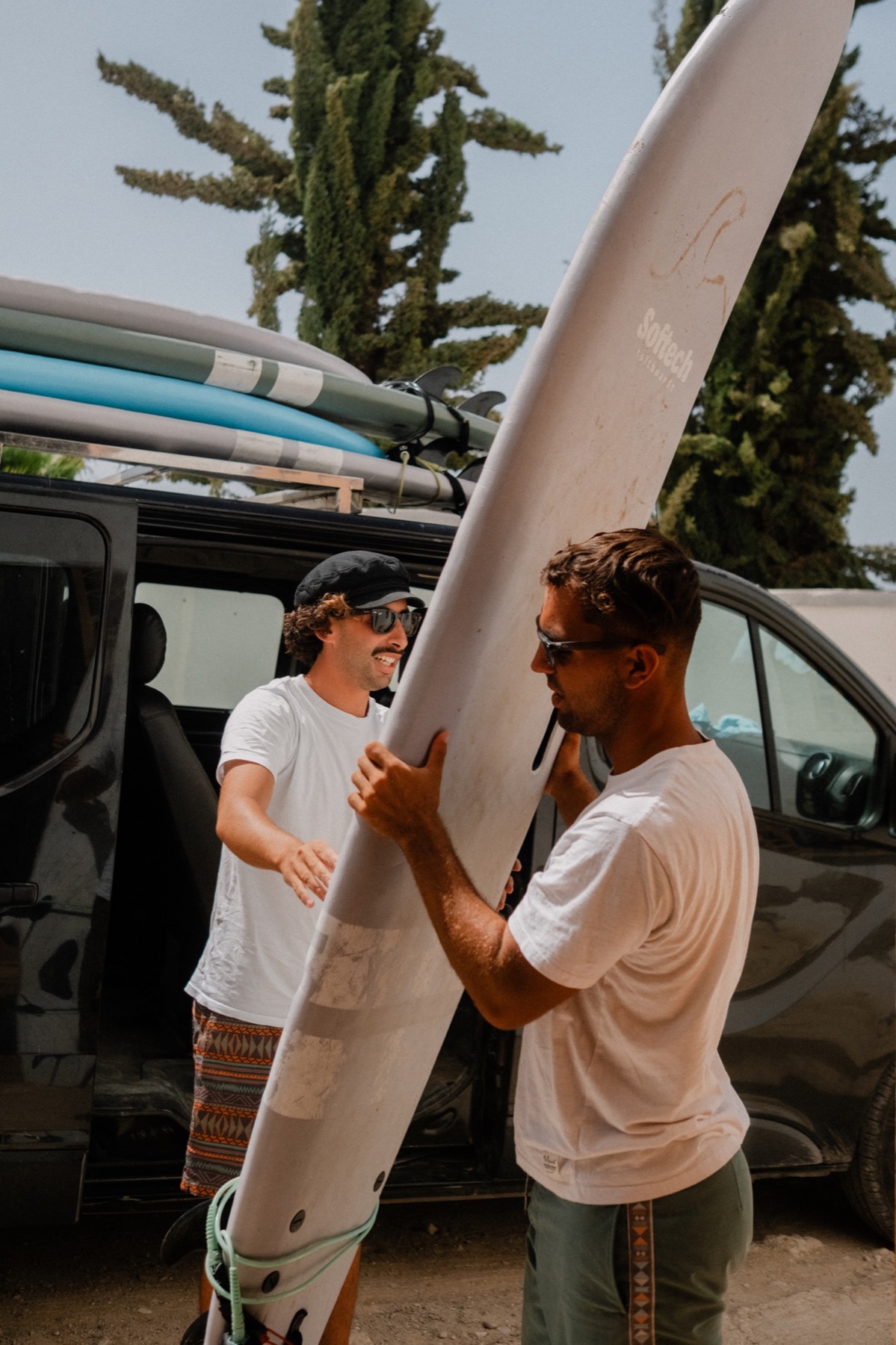 Surfers unloading boards from the van