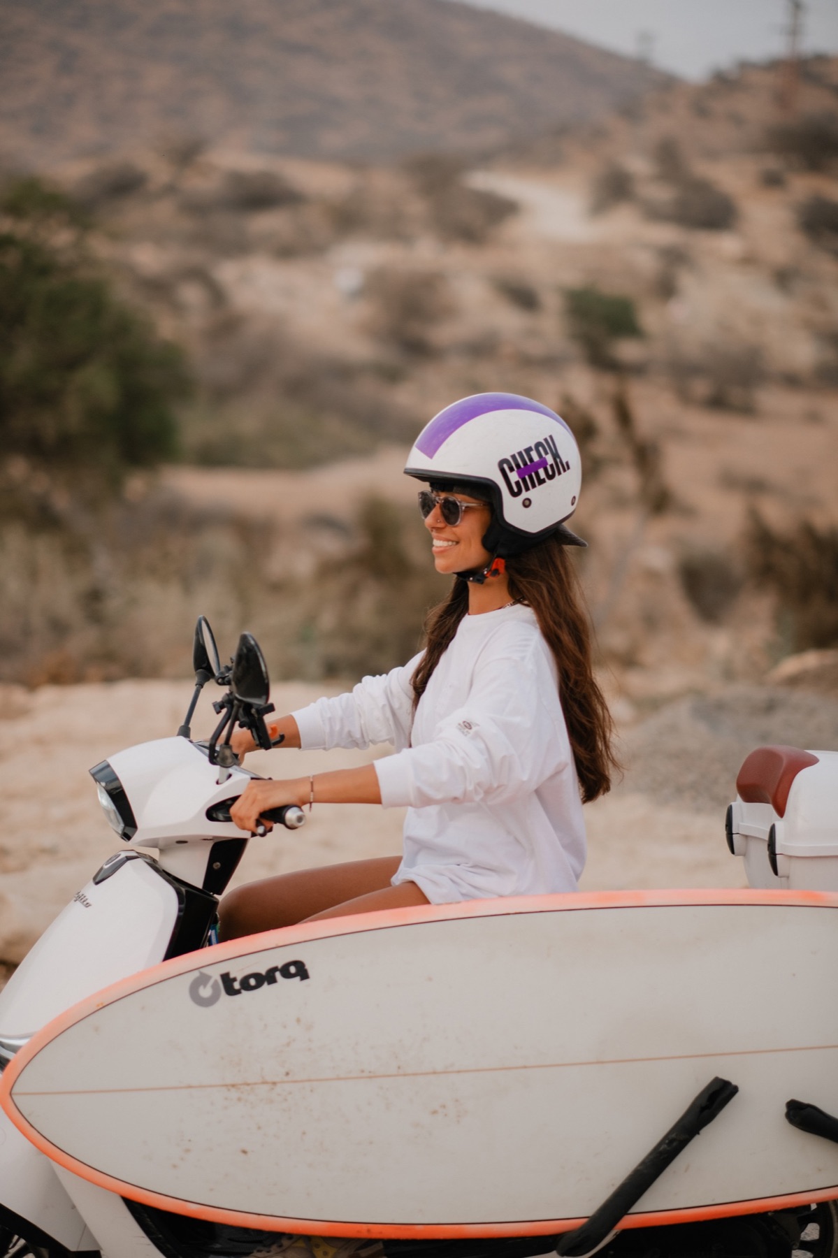 Surfer beside a scooter in Morocco