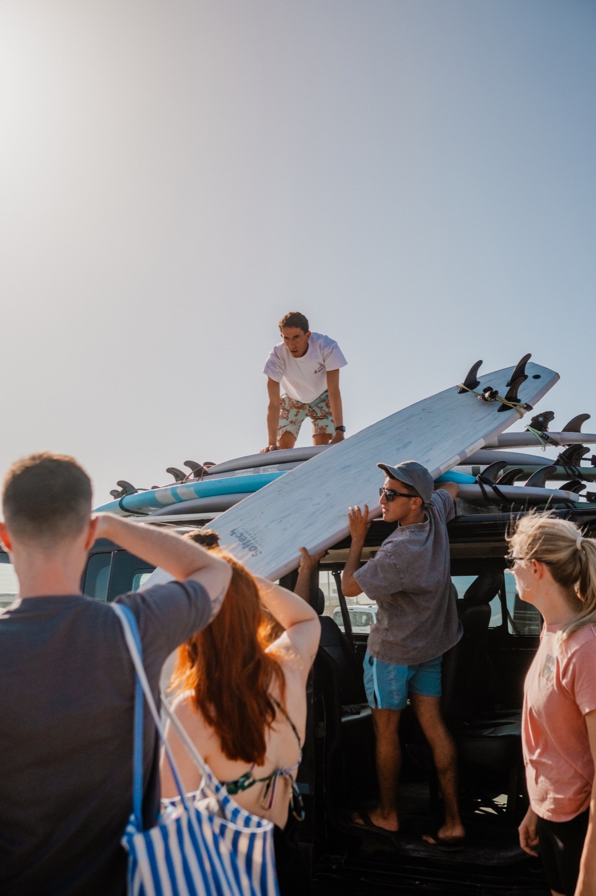 The group preparing surfboards on the beach