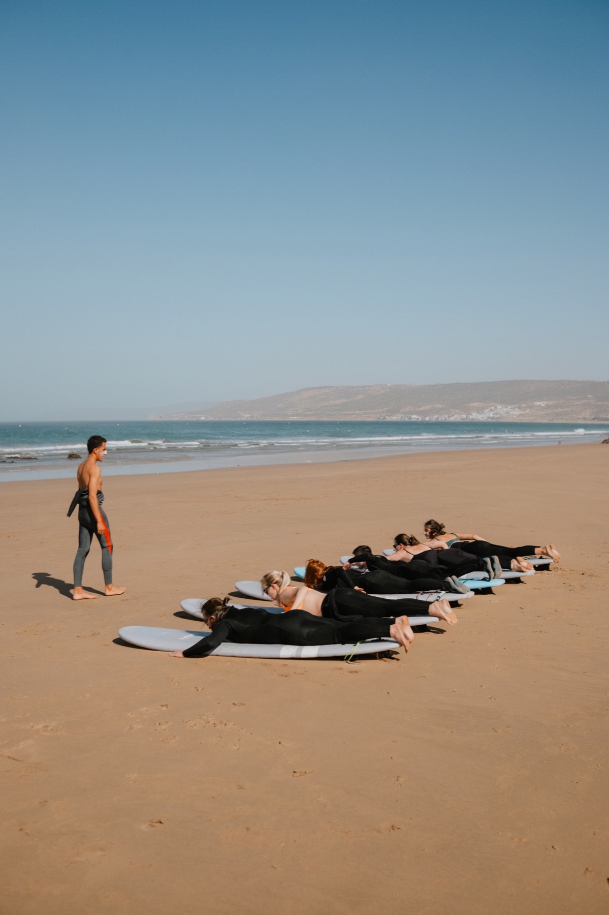 Surfboards laid out on the sand