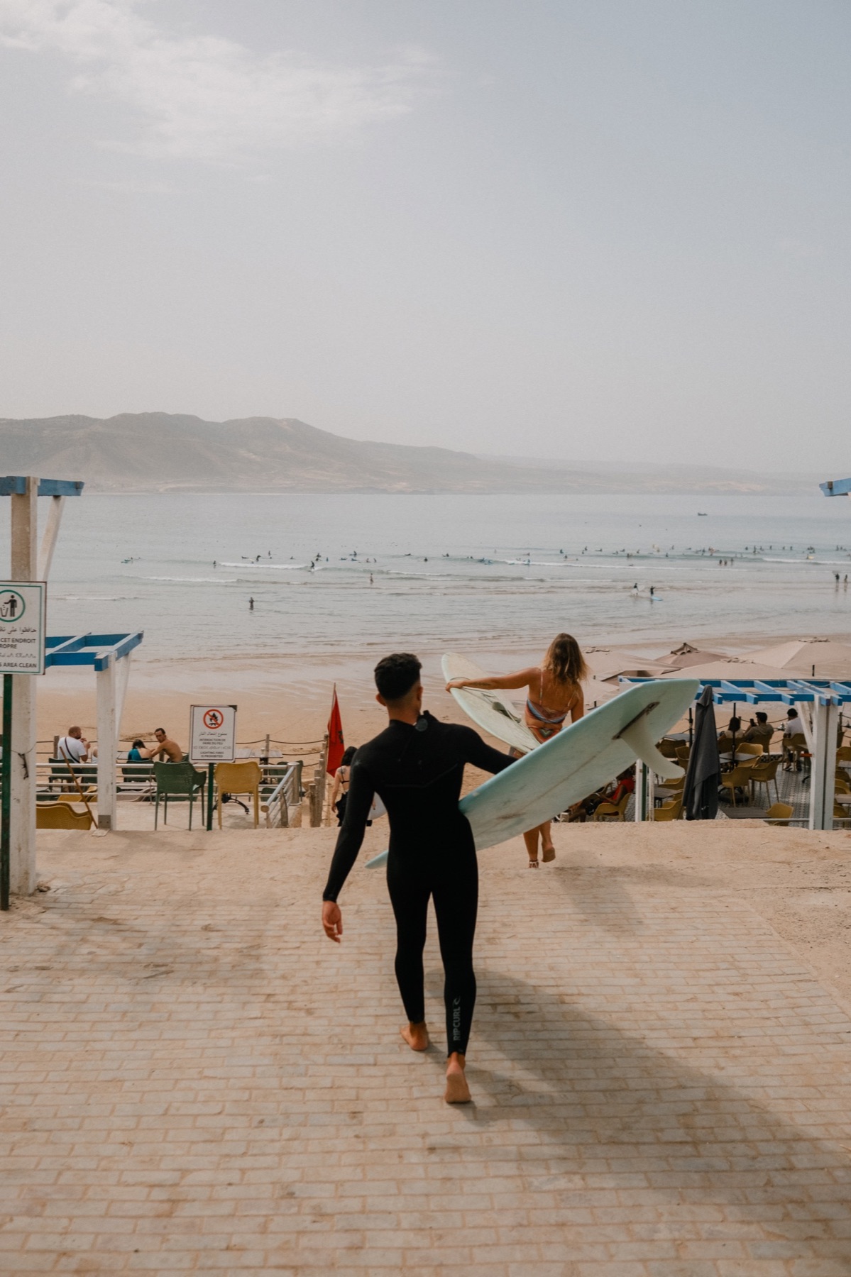 Surfer walking towards the beach